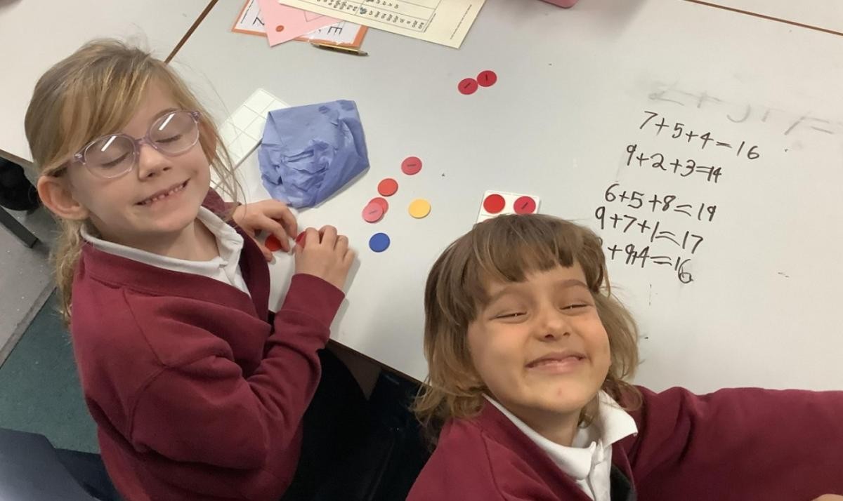 Using concrete resources to help us add three 1-digit numbers.