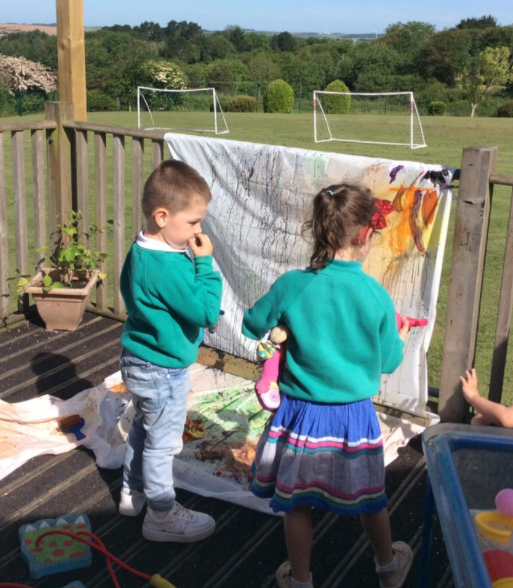 Exploring colour mixing using paint sprayers - so exciting!