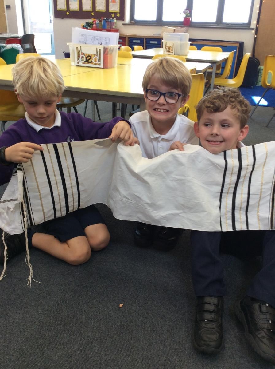 Year 2 enjoying a discussion about Jewish artefacts.