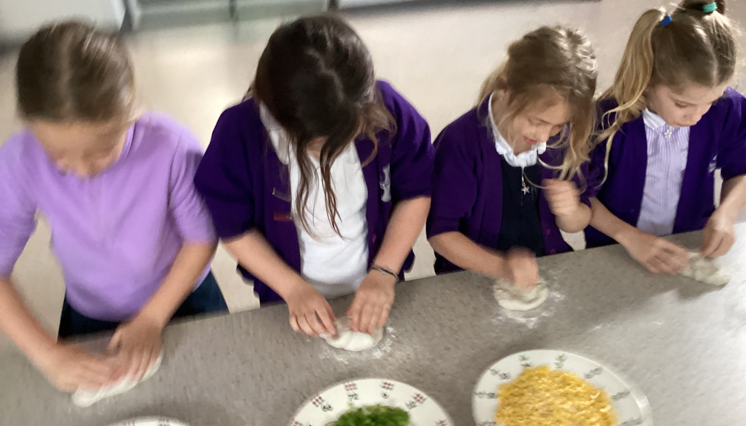 Pupils practised making a pizza base using fresh pizza dough, learning how to shape, stretch, and prepare it ready for toppings. 🍕👏