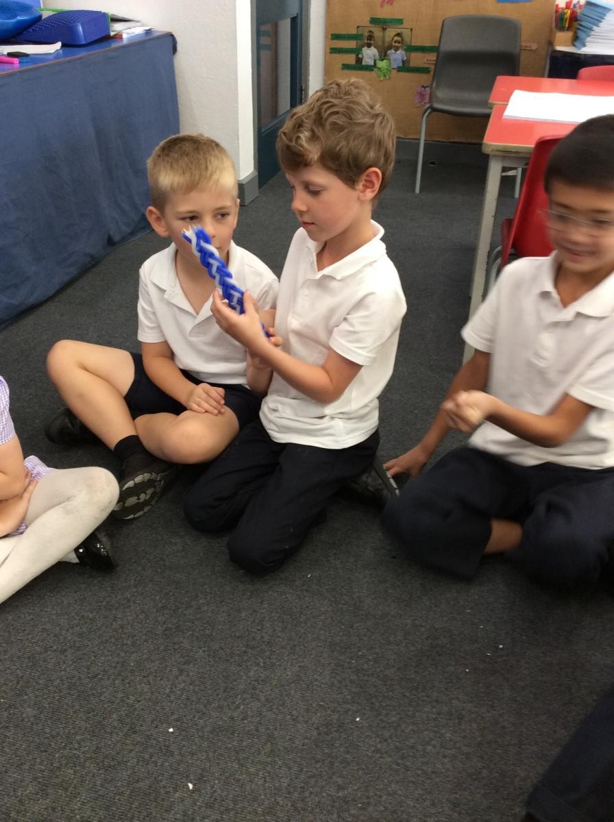Year 2 discussing Jewish artefacts.