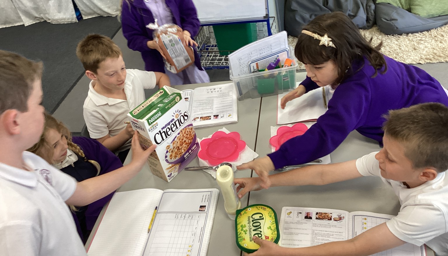 Pupils evaluated a range of existing food products such as bread, cereals, and butter, examining packaging and exploring taste, smell, appearance, and texture to understand what makes a successful product.