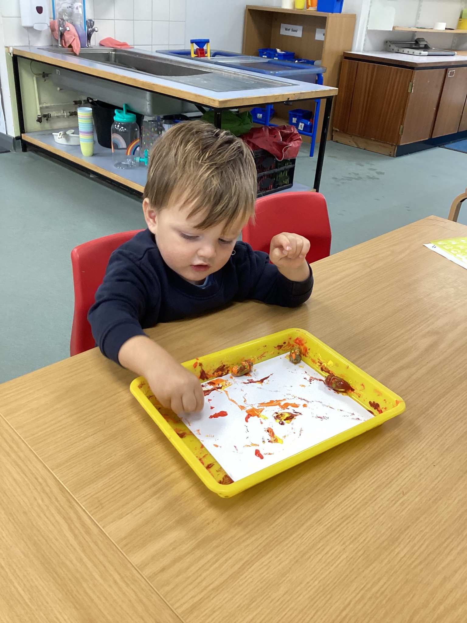 Rolling acorns through the paint!