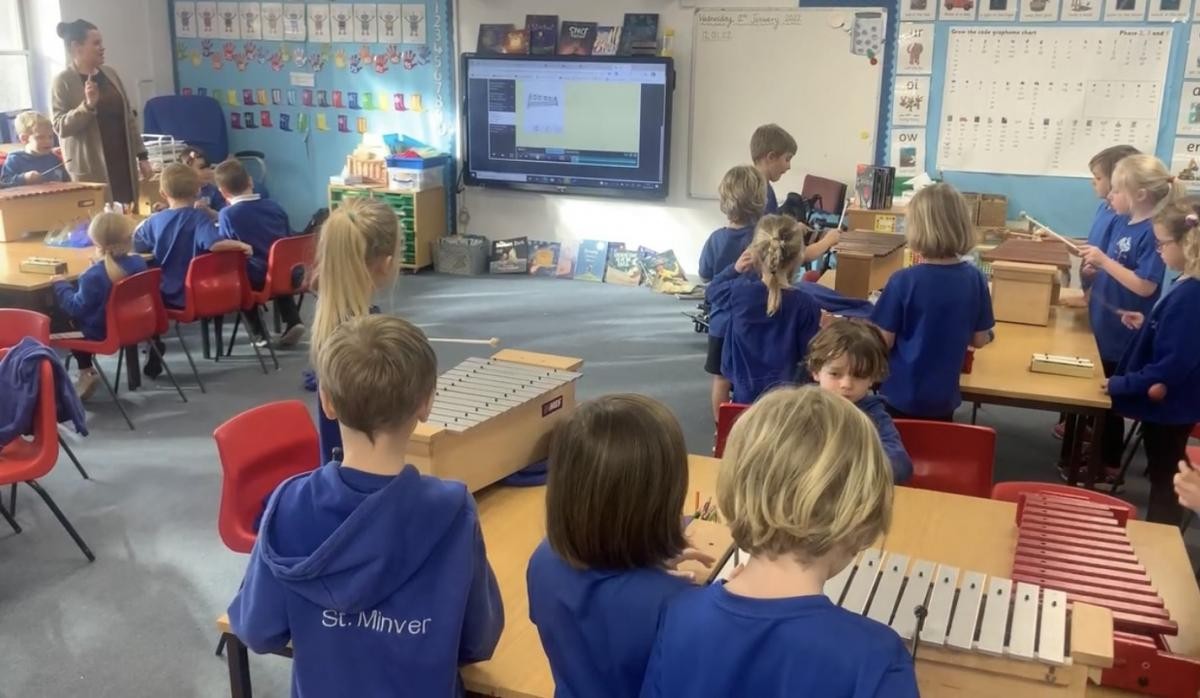 Playing along with glockenspiels.