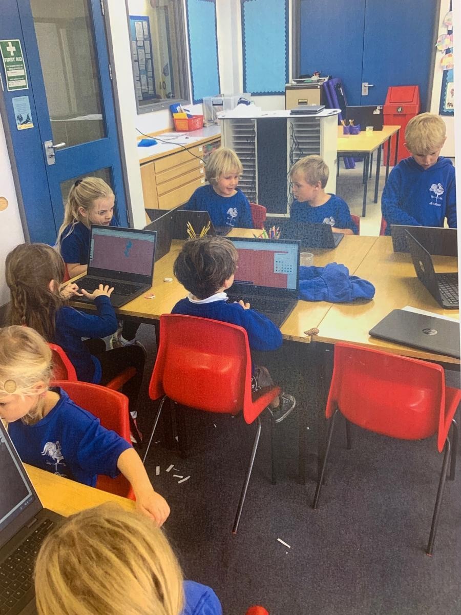 Class 1 using Chrome books to draw in  a digital painting lesson in IT.