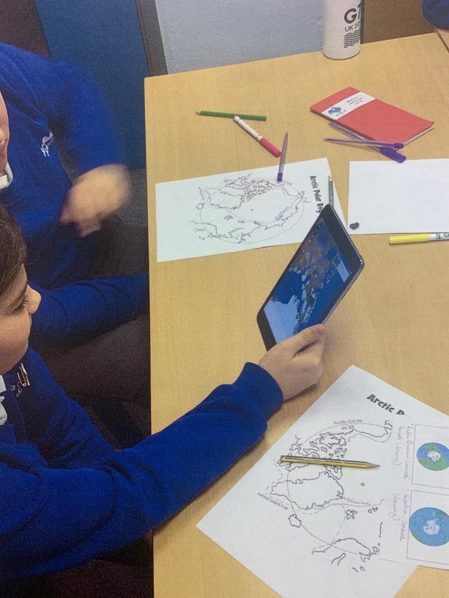 Class 6 using Google Earth on iPads to research settlements in the Arctic Circle in Geography.