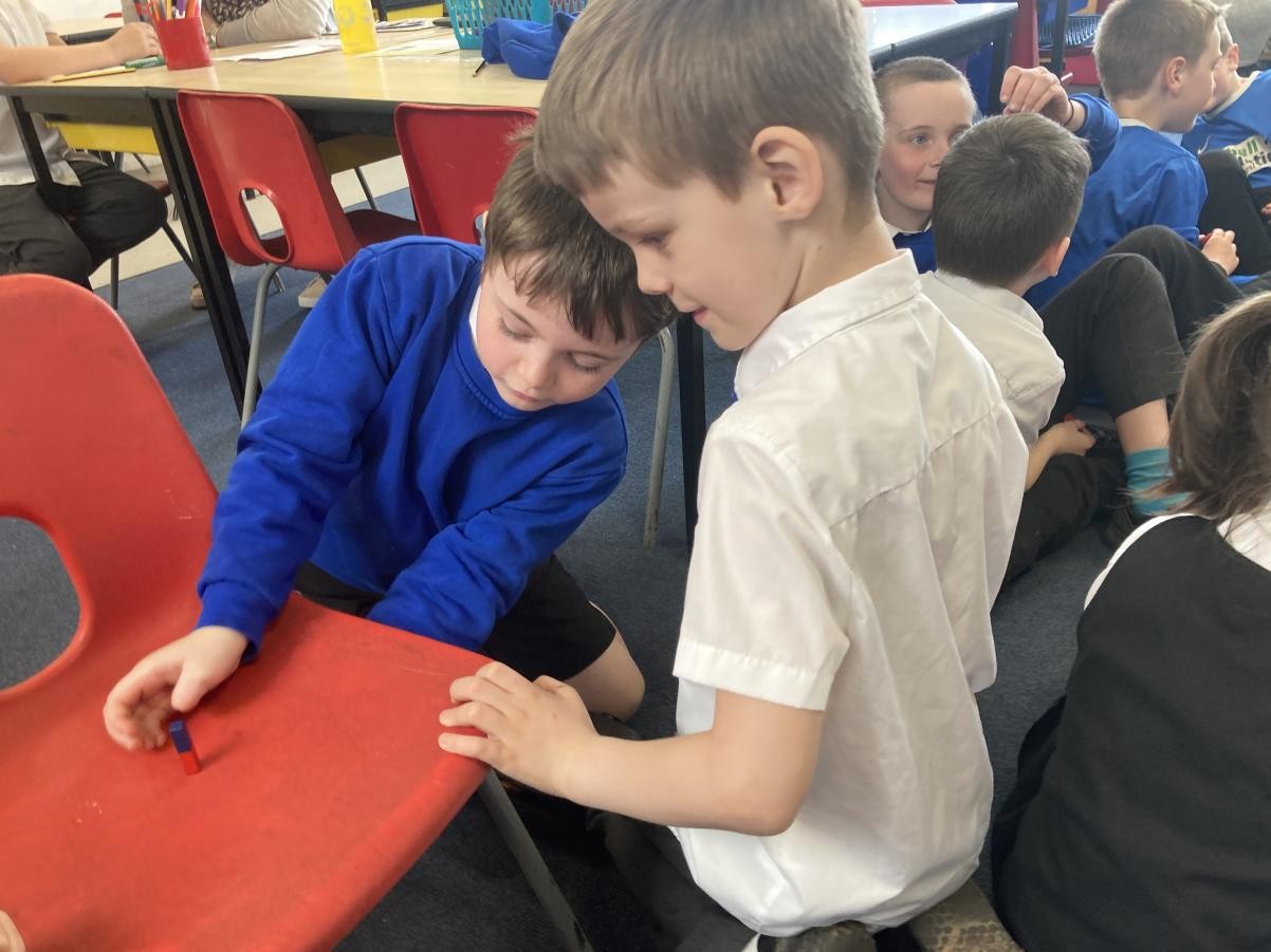 Exploring magnets and how they can attract some materials, but not others. 