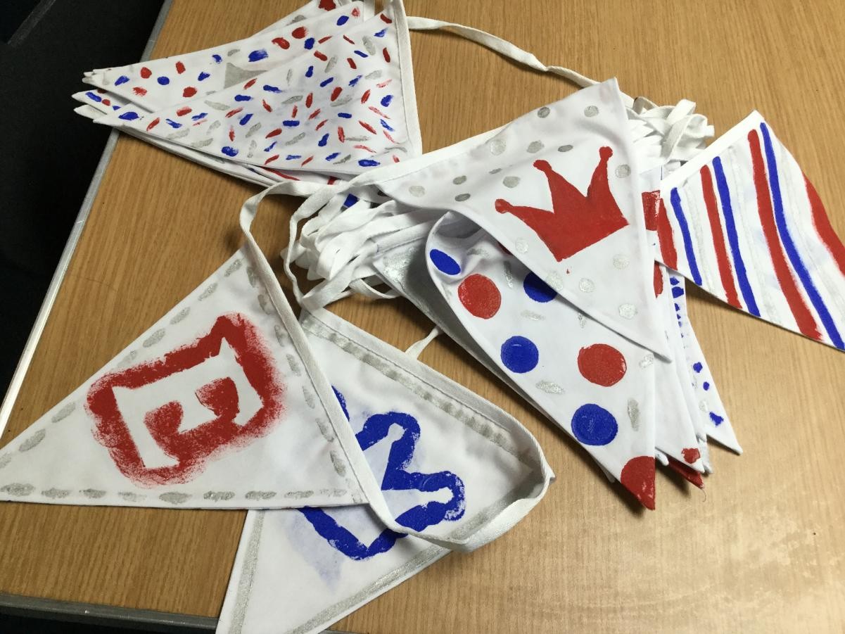 Textiles. Painting and stenciling Platinum Jubilee bunting for a community project