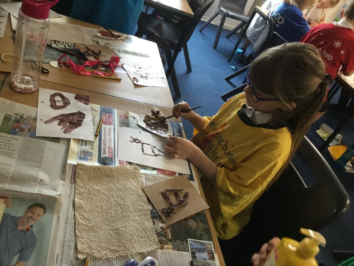 Print. Stone Age images onto natural tie dyed fabric