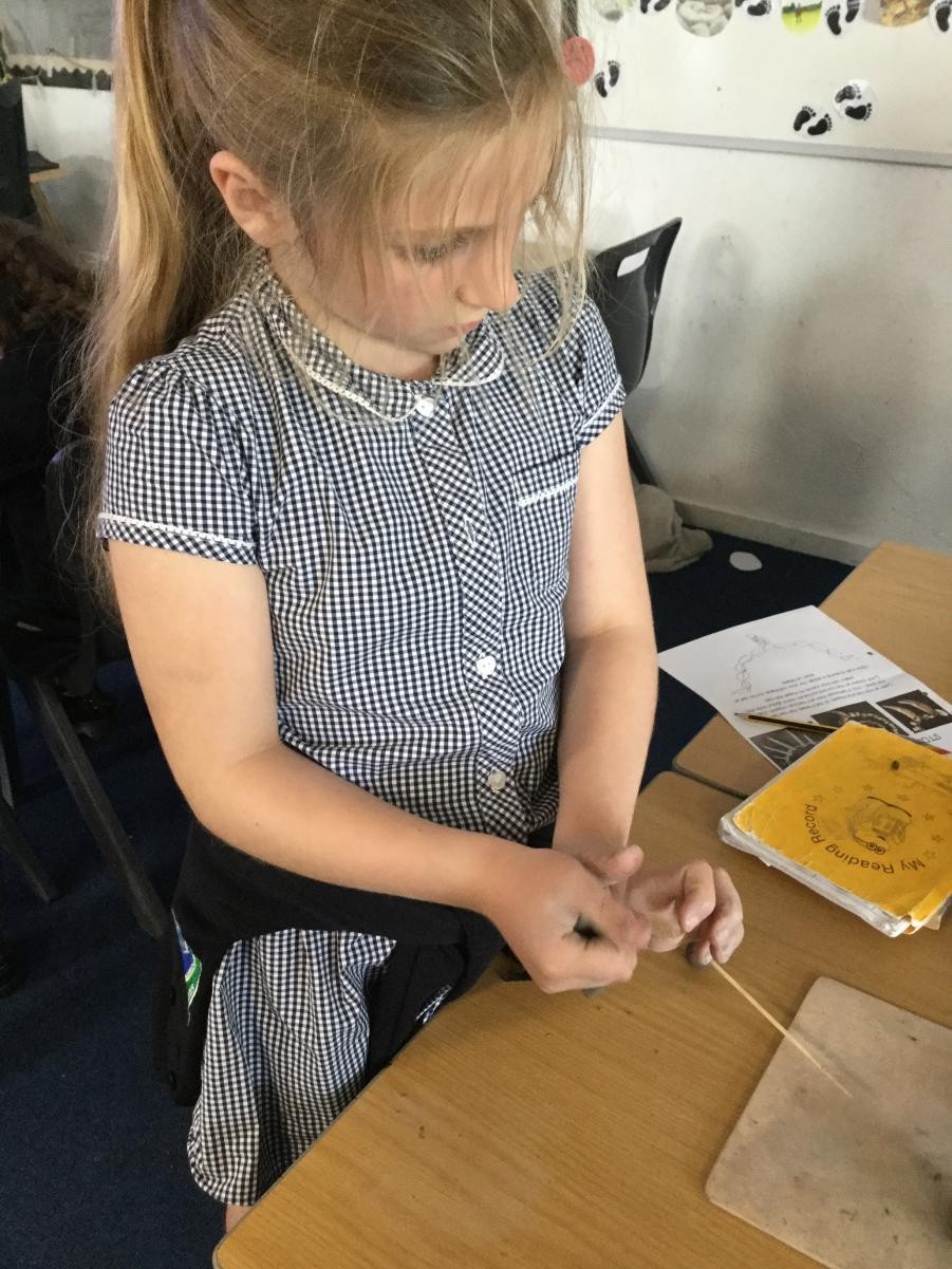 Sculpture. Shaping clay for Stone Age necklace beads