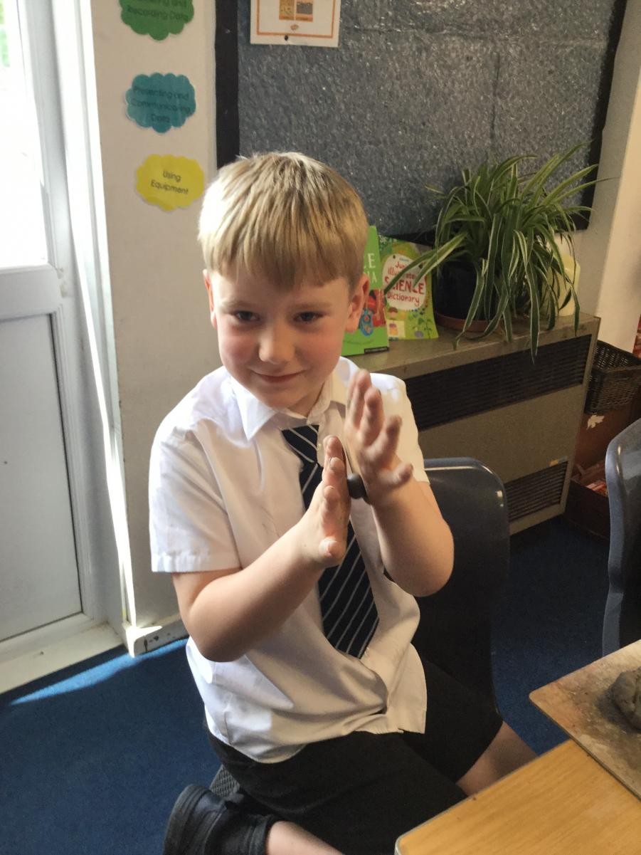 Sculpture. Shaping clay for Stone Age necklace beads