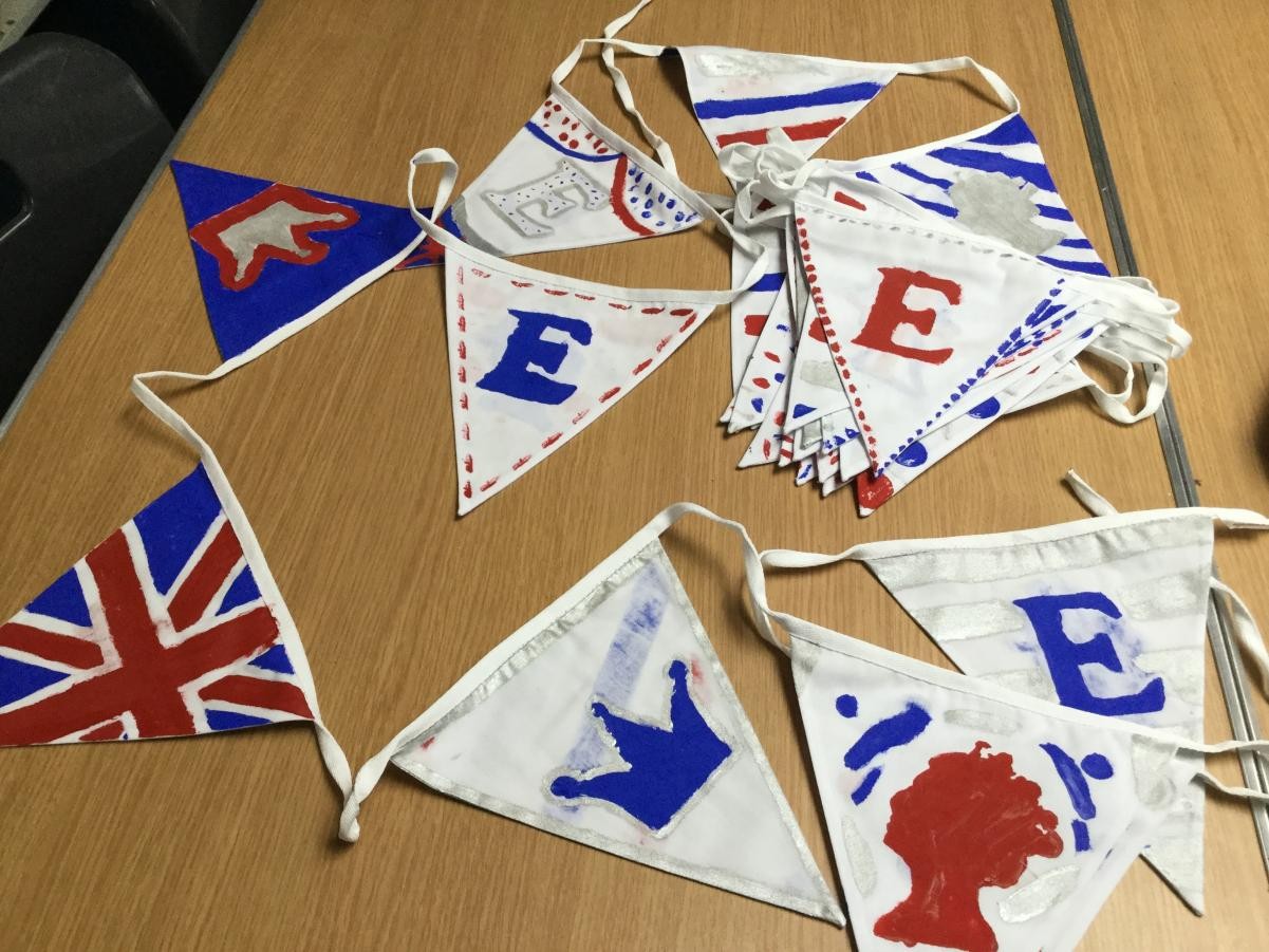 Textiles. Painting and stenciling Platinum Jubilee bunting for a community project