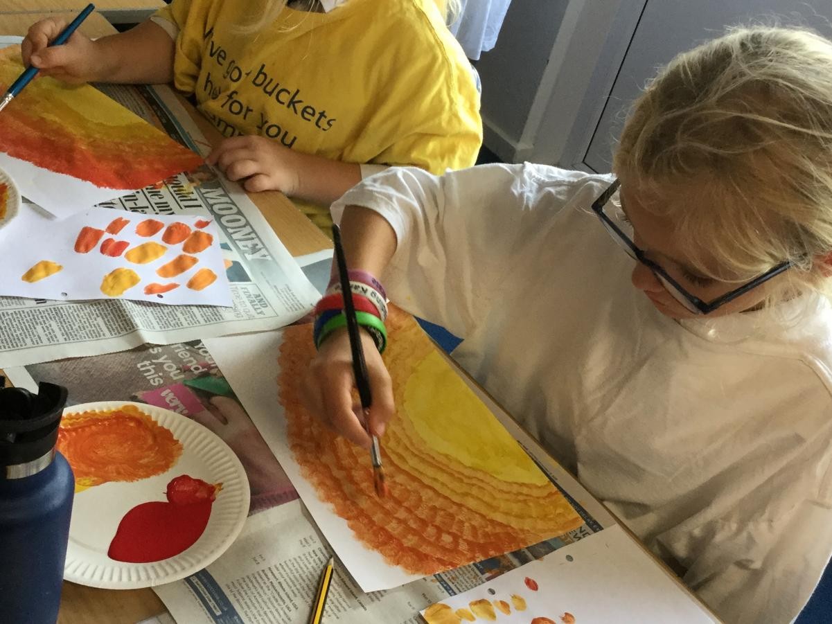 Paint. Mixing warm colours for backgrounds