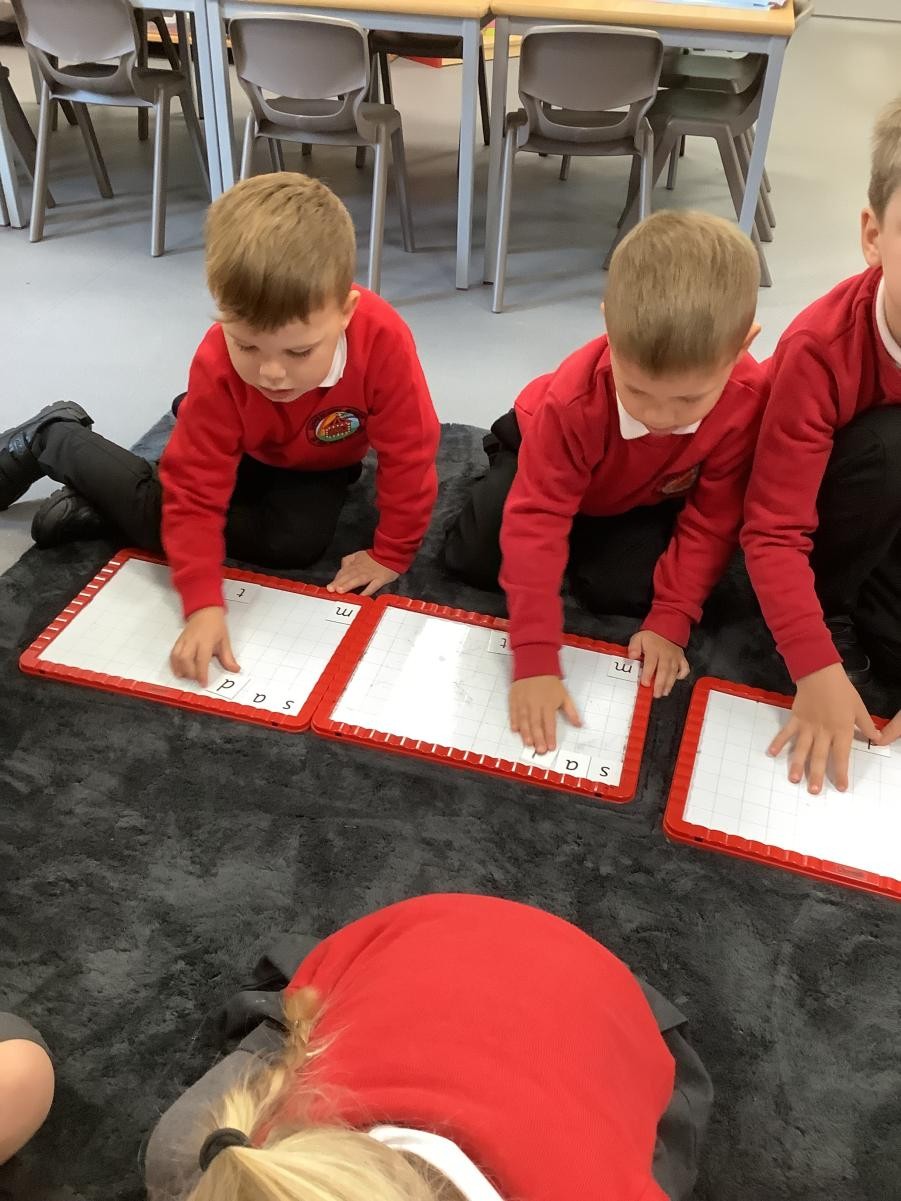 Using the magnetic boards to make words we can read