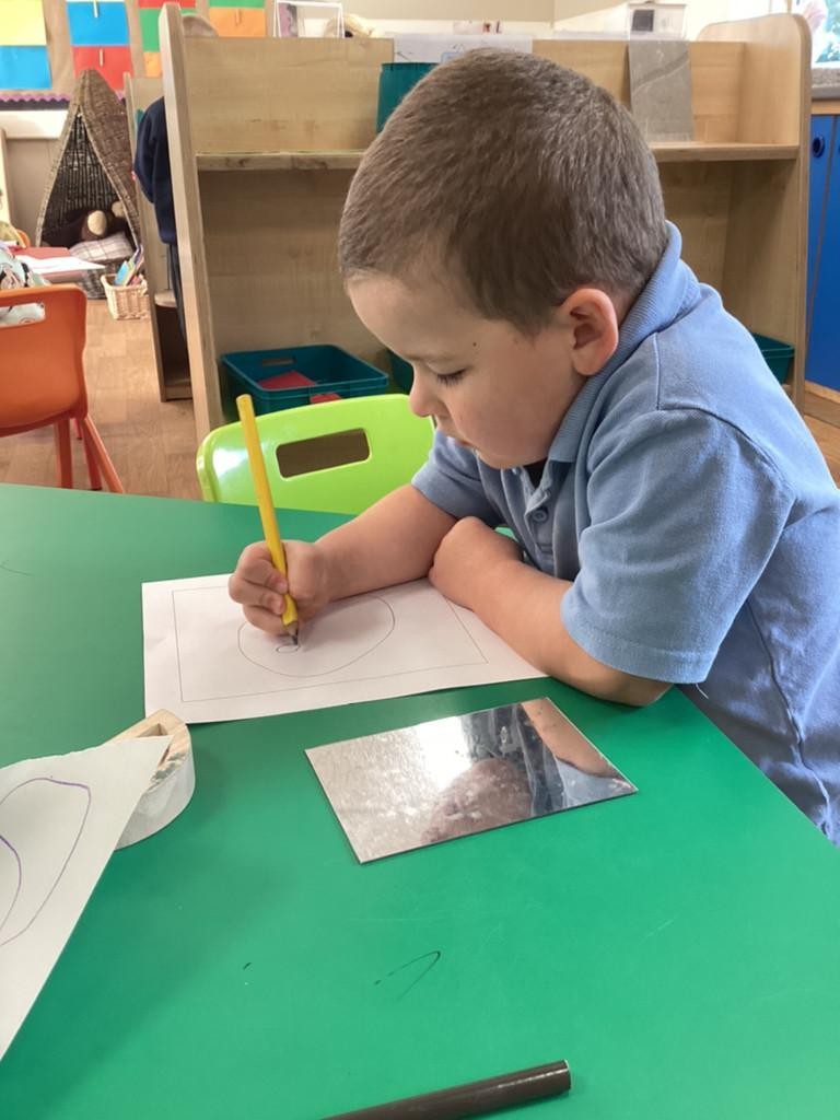 We have been using mirrors to help us draw our own self-portraits! 