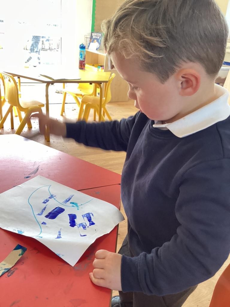 We explored using cardboard to make marks - we made our own big waves! 