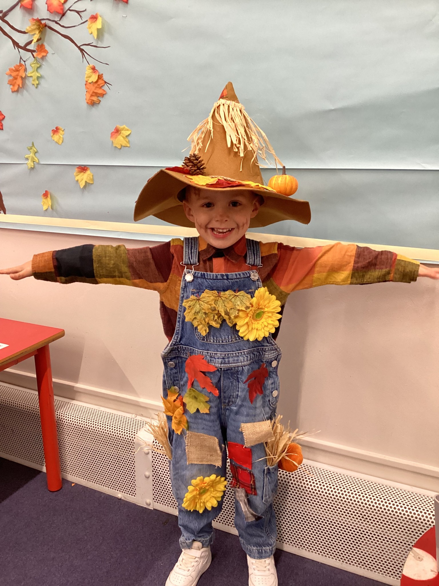 The children all dressed up as scarecrows for their Harvest Assembly.