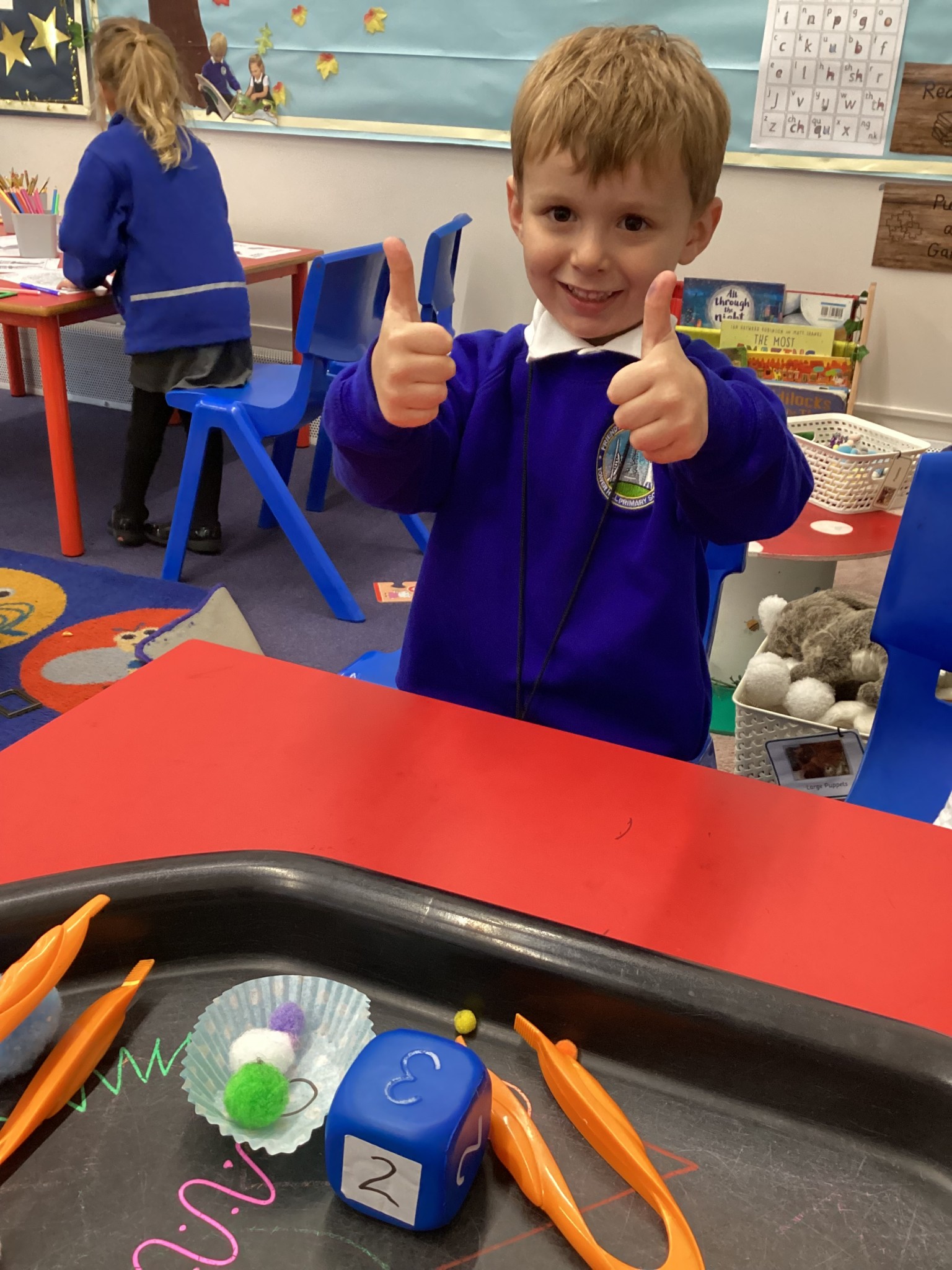 Matching pom poms to the number on the dice. 