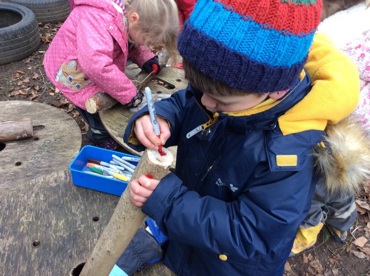 First we found a good log, then we drew a face on our log dog.