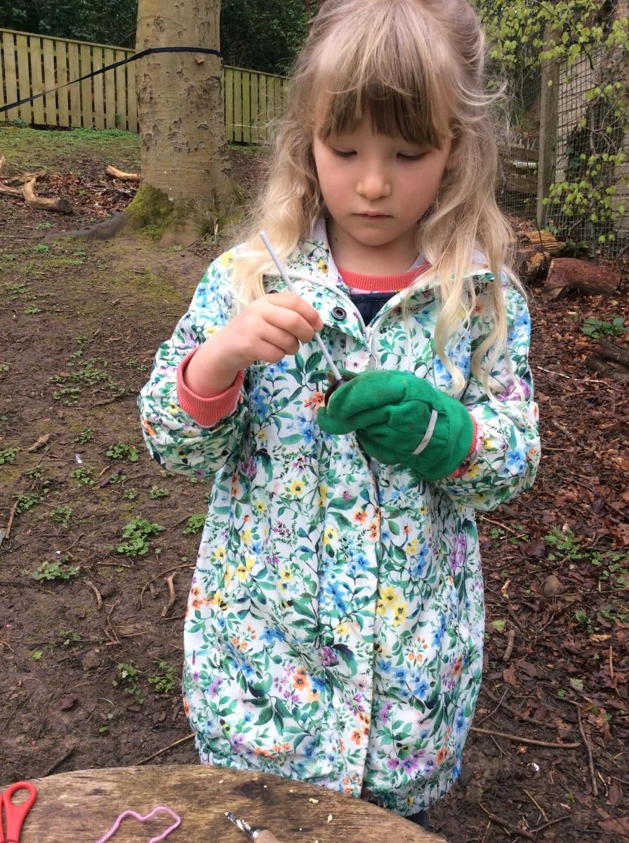 Then we used a crochet hook to thread some yarn through the conker.