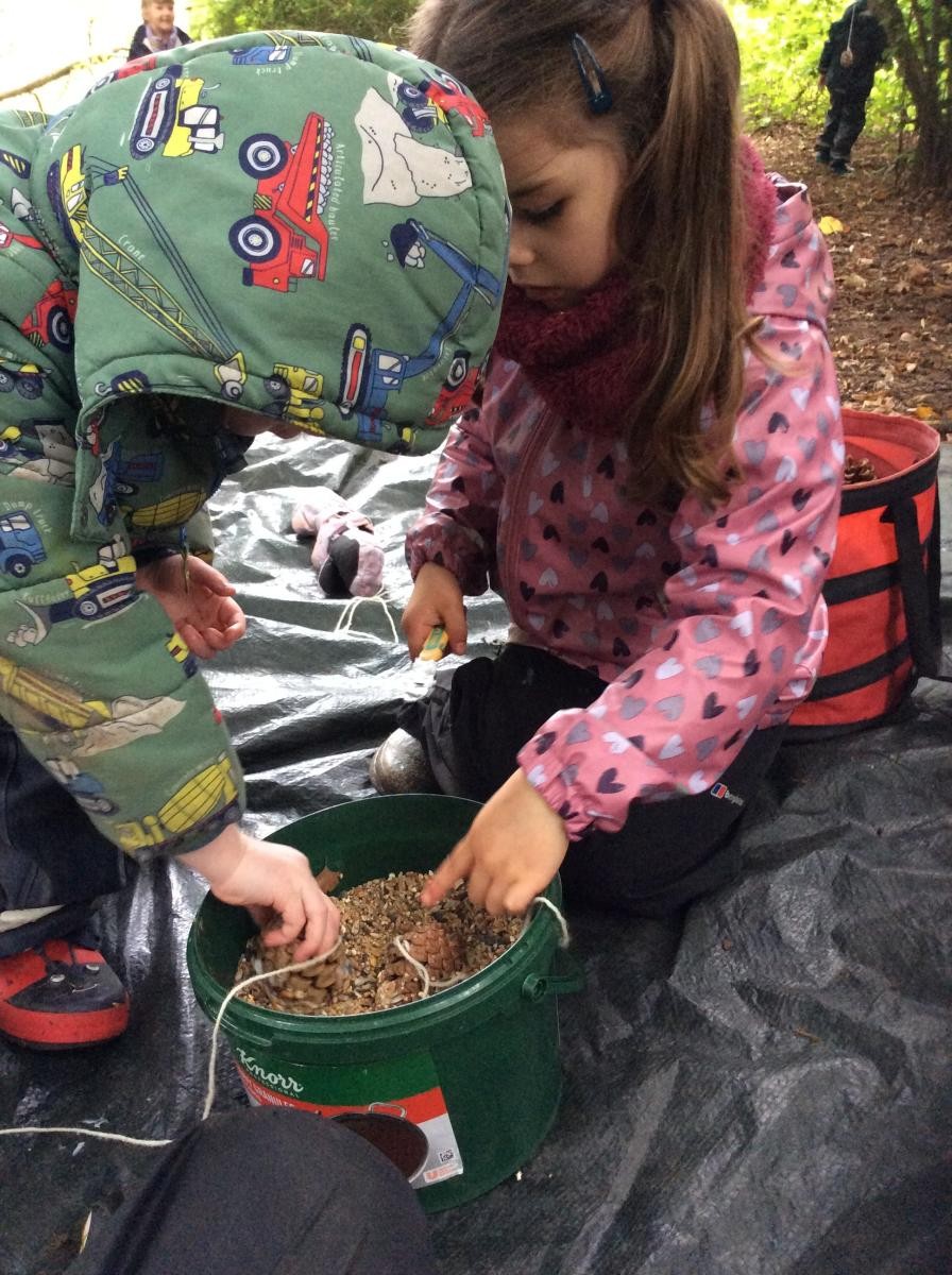 Next, we dipped the pine cone into the bird seed and rolled it around.