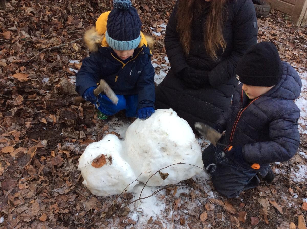 We carried a snowman into the woods to play with.