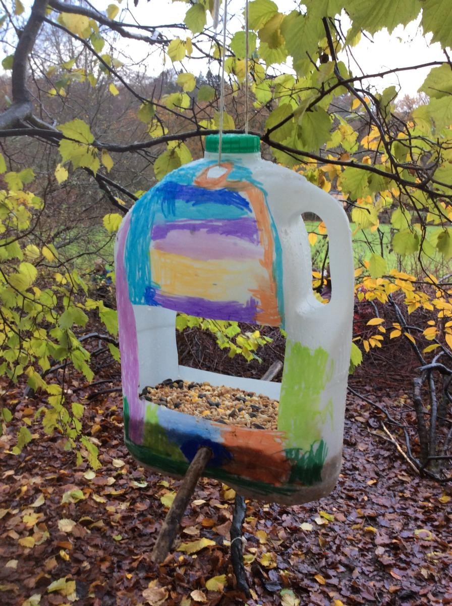 We reused and decorated old milk bottles and filled them with bird seed.