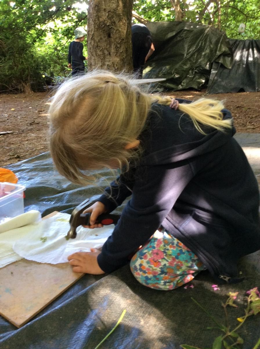 We placed flowers and leaves between a fold of fabric and hit them with a hammer.