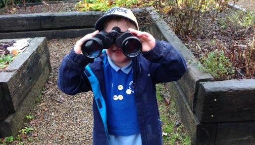 Child looking through binoculars 