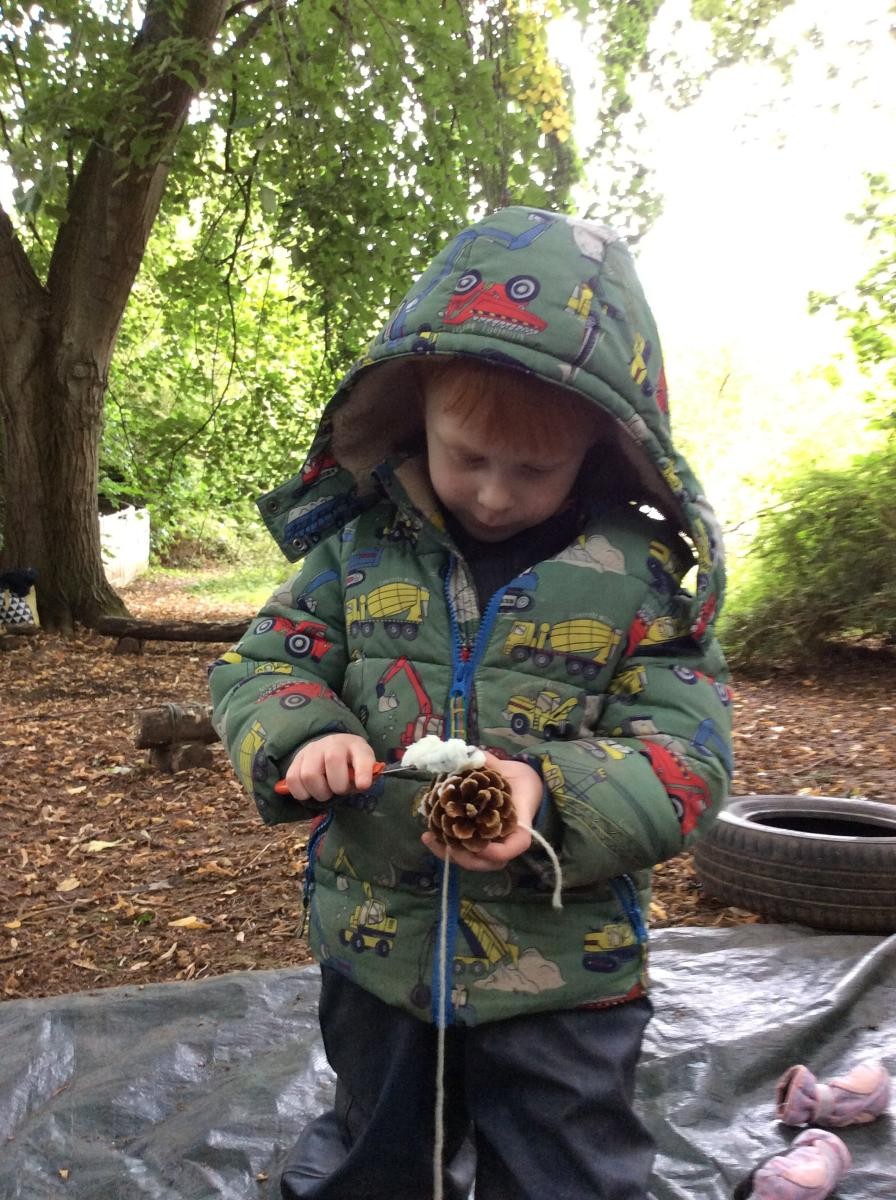 Then we spread lard onto the pine cone.