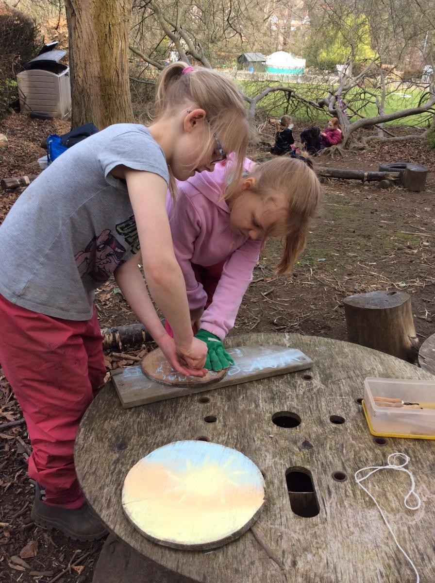 Some of us used palm drills to make a hole in these wood discs.