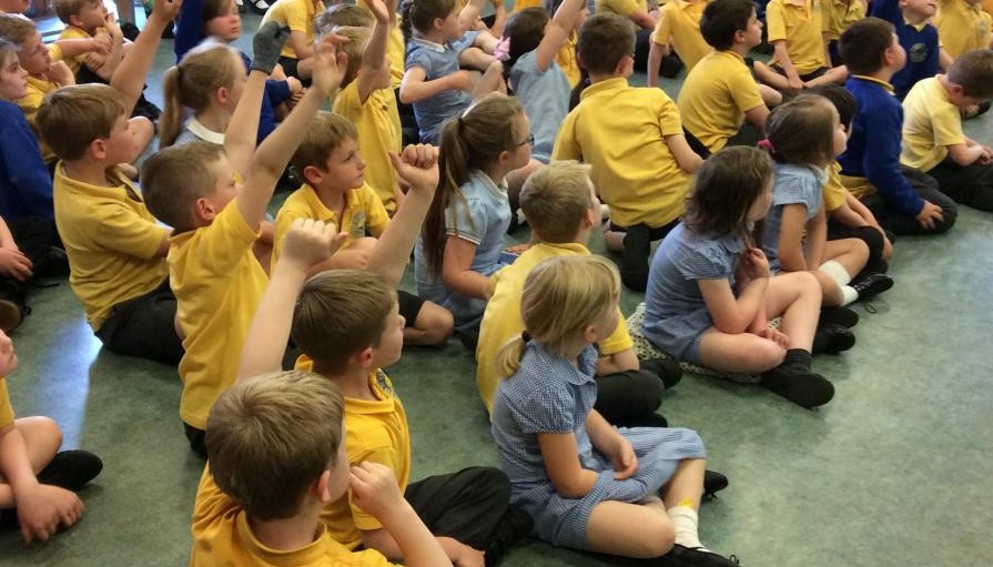 Children sat in hall 