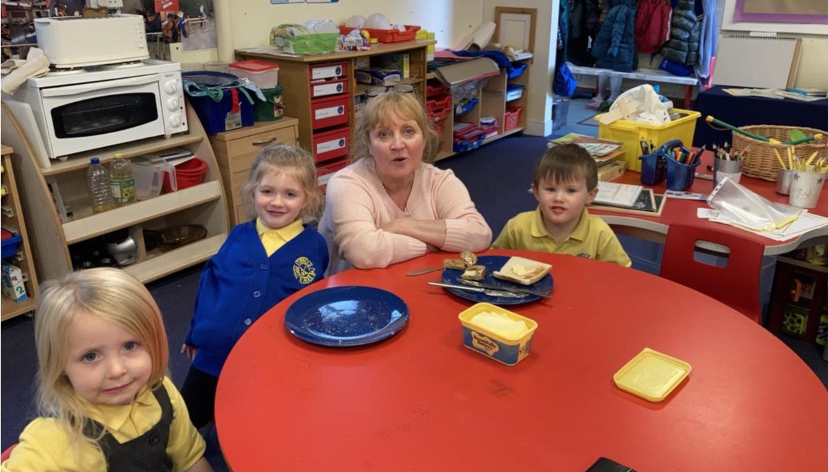 Children sat at a table with adult