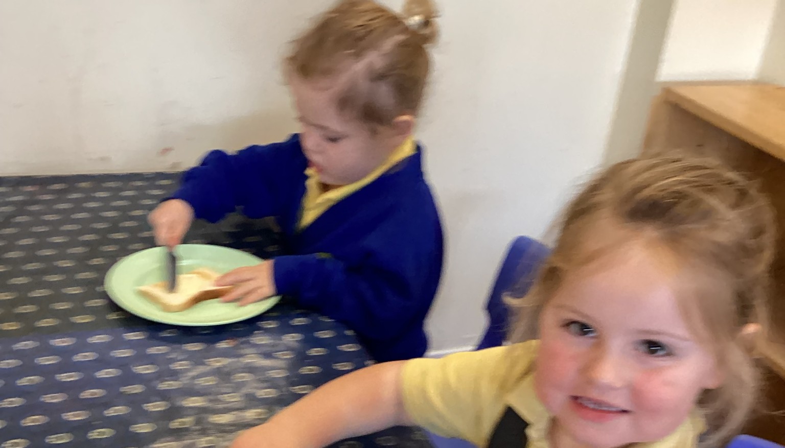 Spreading butter and jam.