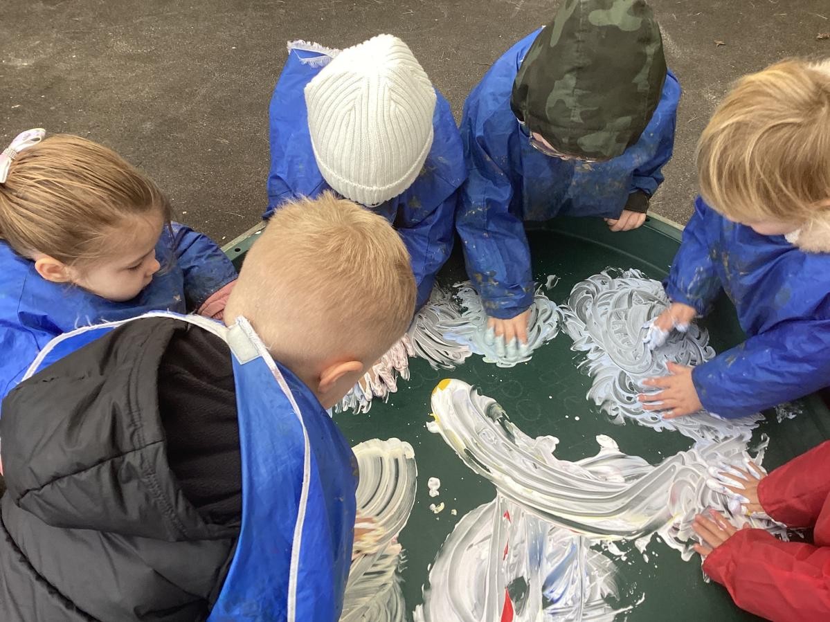 Nursery children enjoying sensory messy play.