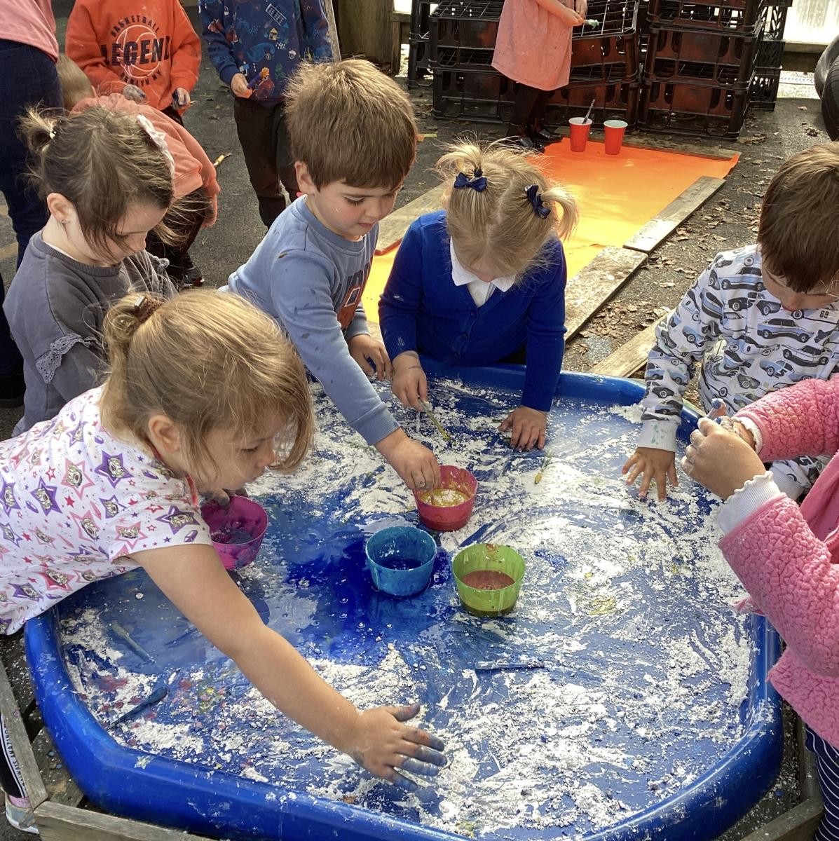 The nursery children enjoying messy play exploration as part of the whole-school art day. 