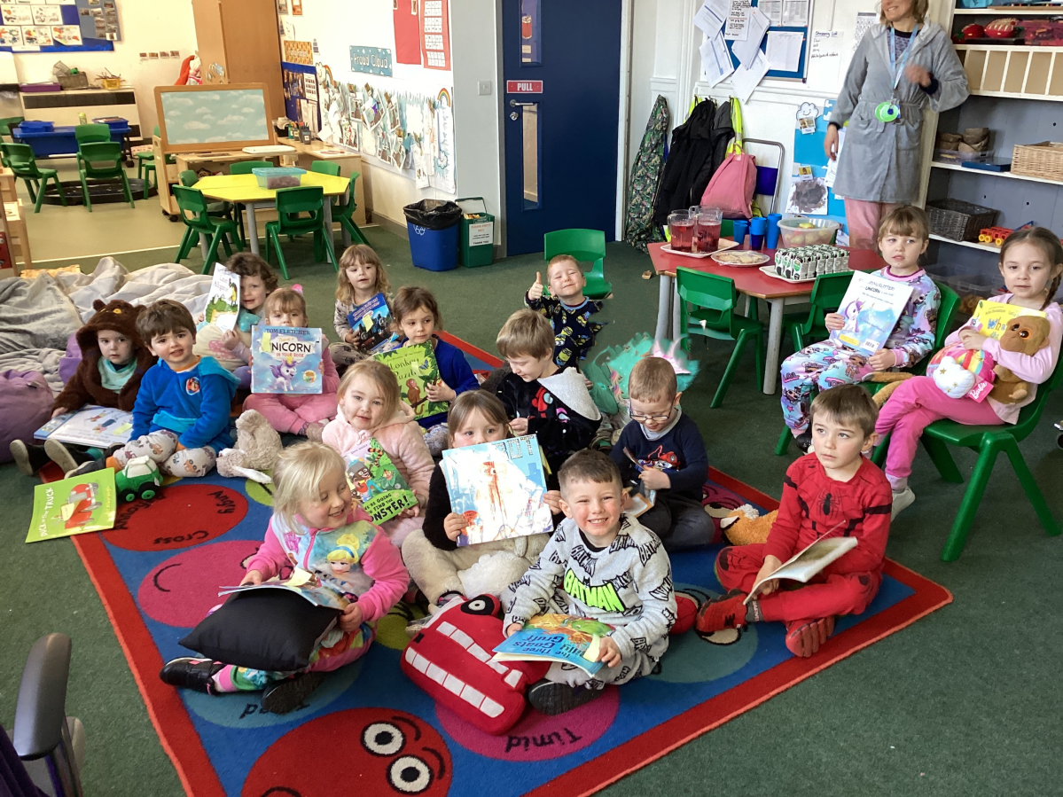 Class 1 nursery and reception children ready to relax and read a book for World Book Day - we had a pyjama party!