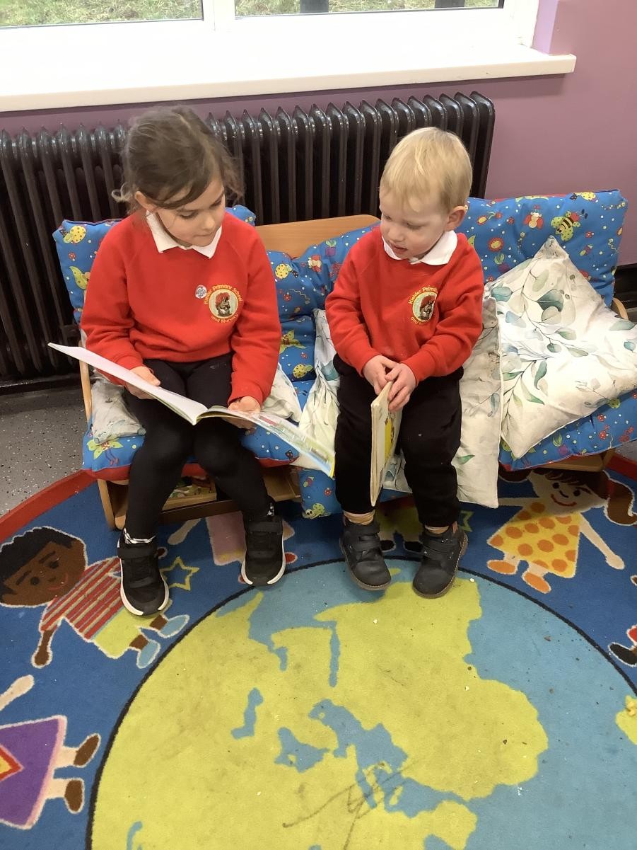 Dakota (Year 1) reading to Dylan (Nursery)