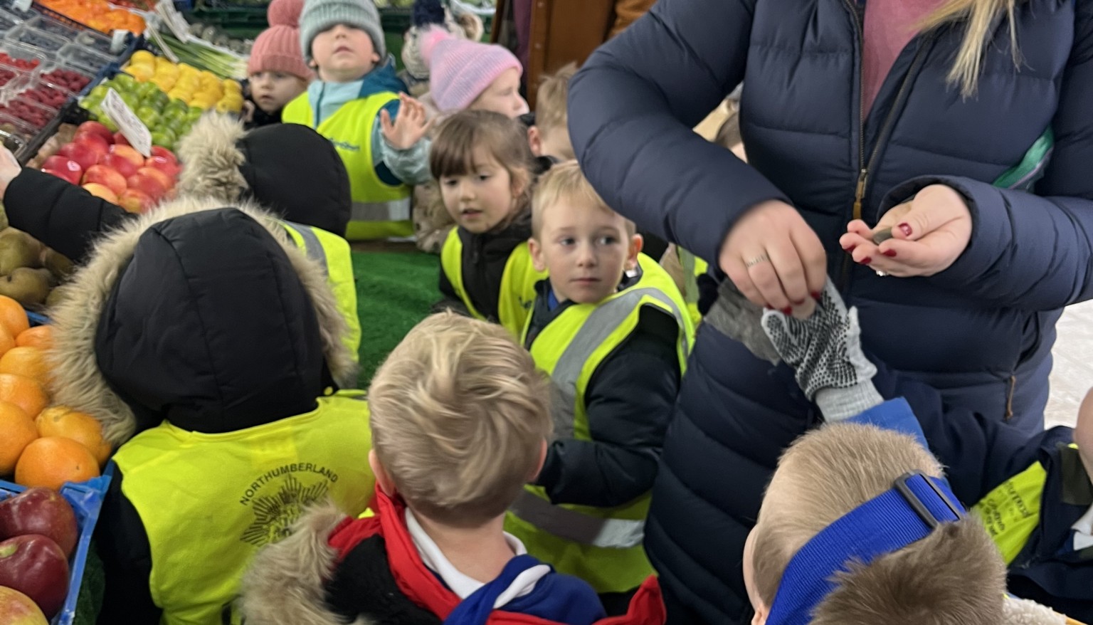 Early Years having fun buying fruit at the market