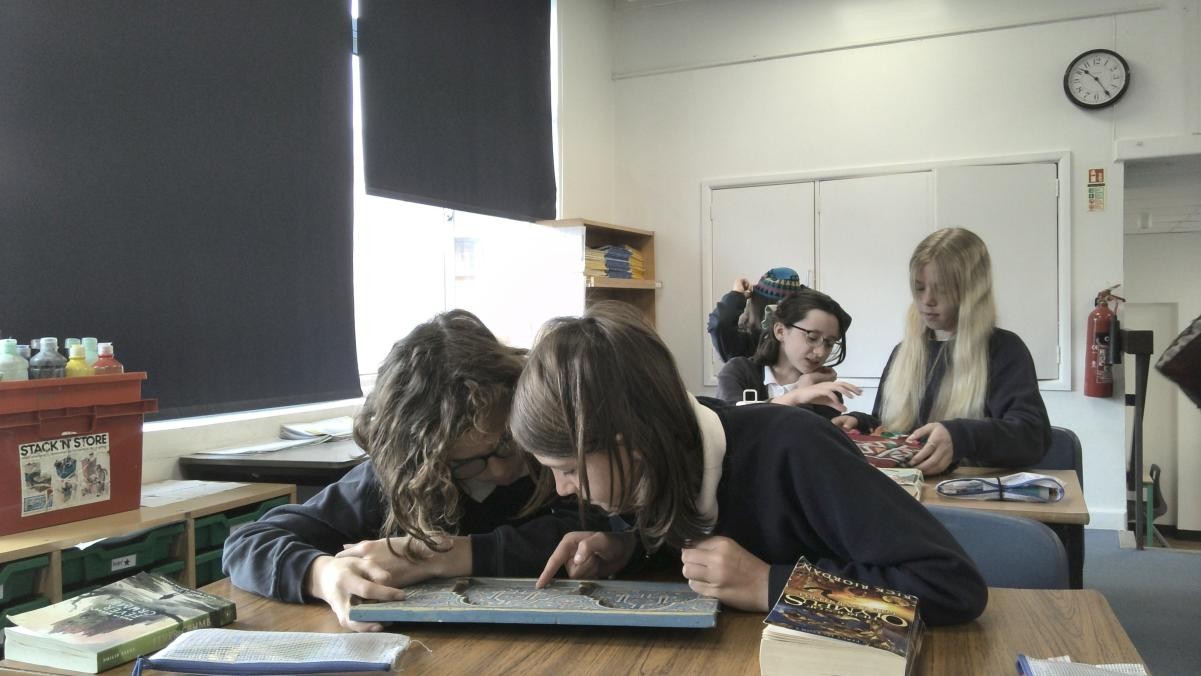 Pupils studying an atlas