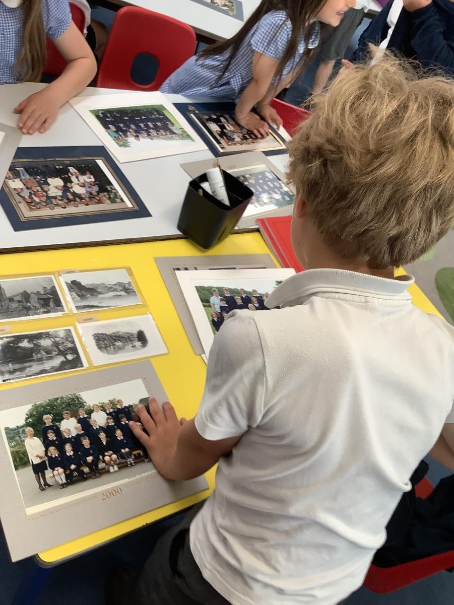 Pupil looking at old photos of school