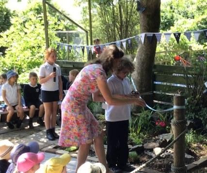 The ribbon is cut, declaring the garden open.
