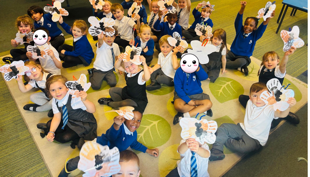 The children made butterflies from their handprints made of different skin colours.