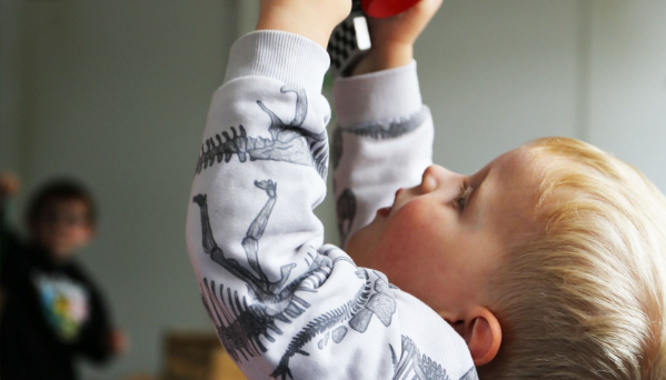 Boy holding a toy looking up