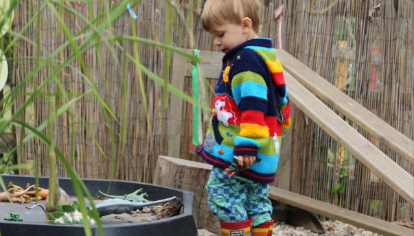 child showing awe and wonder at outdoor learning resources