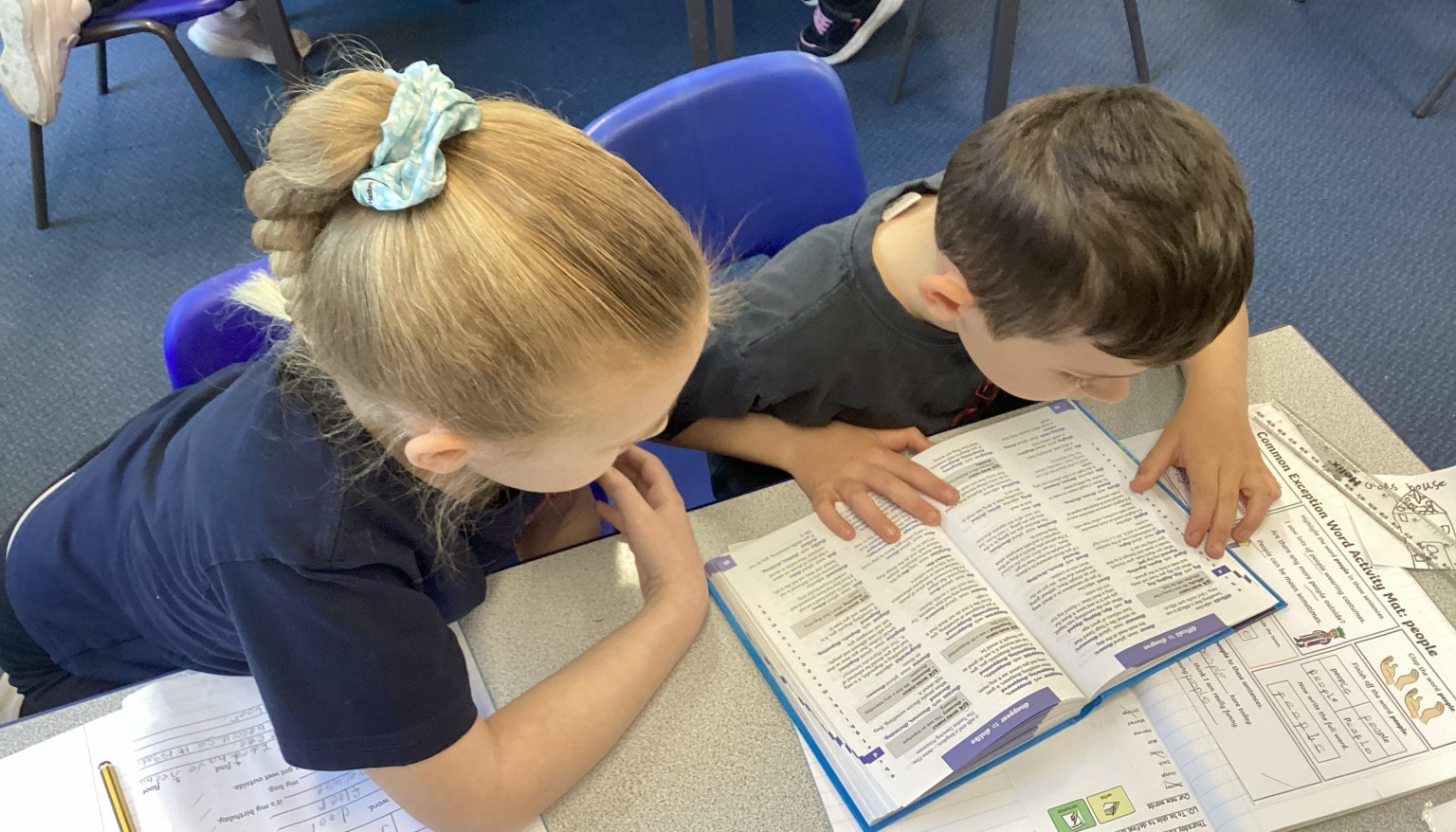 Using a dictionary to find definitions for new words.