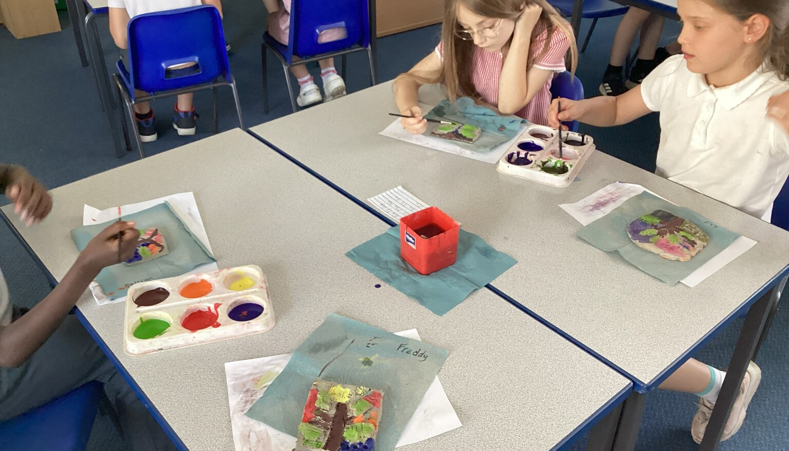 Painting our clay tiles in art!