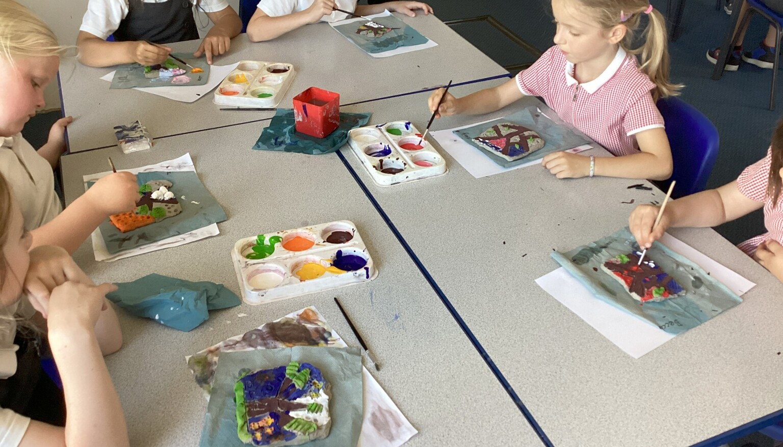 Painting our clay tiles in art!