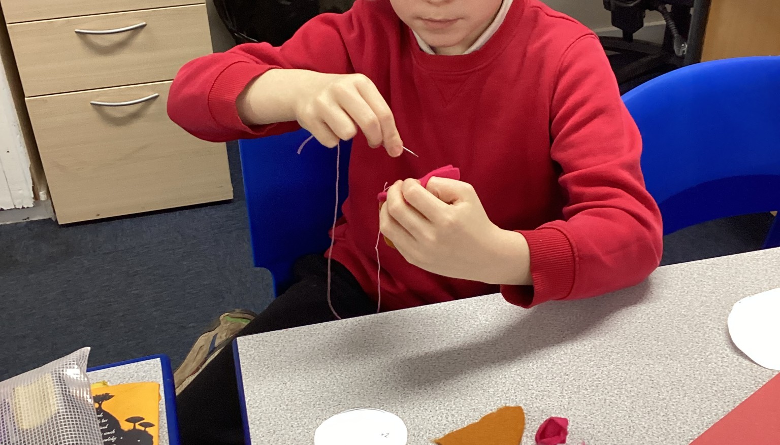 Sewing soft toys for book bags for nursery.