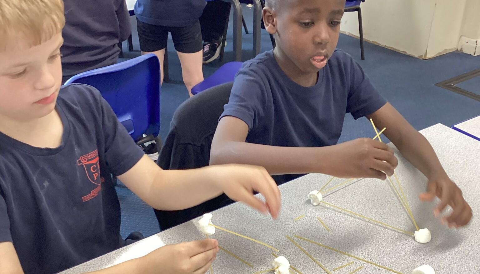 Making sculptures using spaghetti and marshmallows in art!